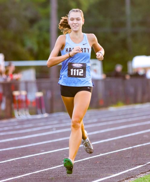 Senior Alaina David sprints to the end of the finish line. David ends with a time of 20:02.