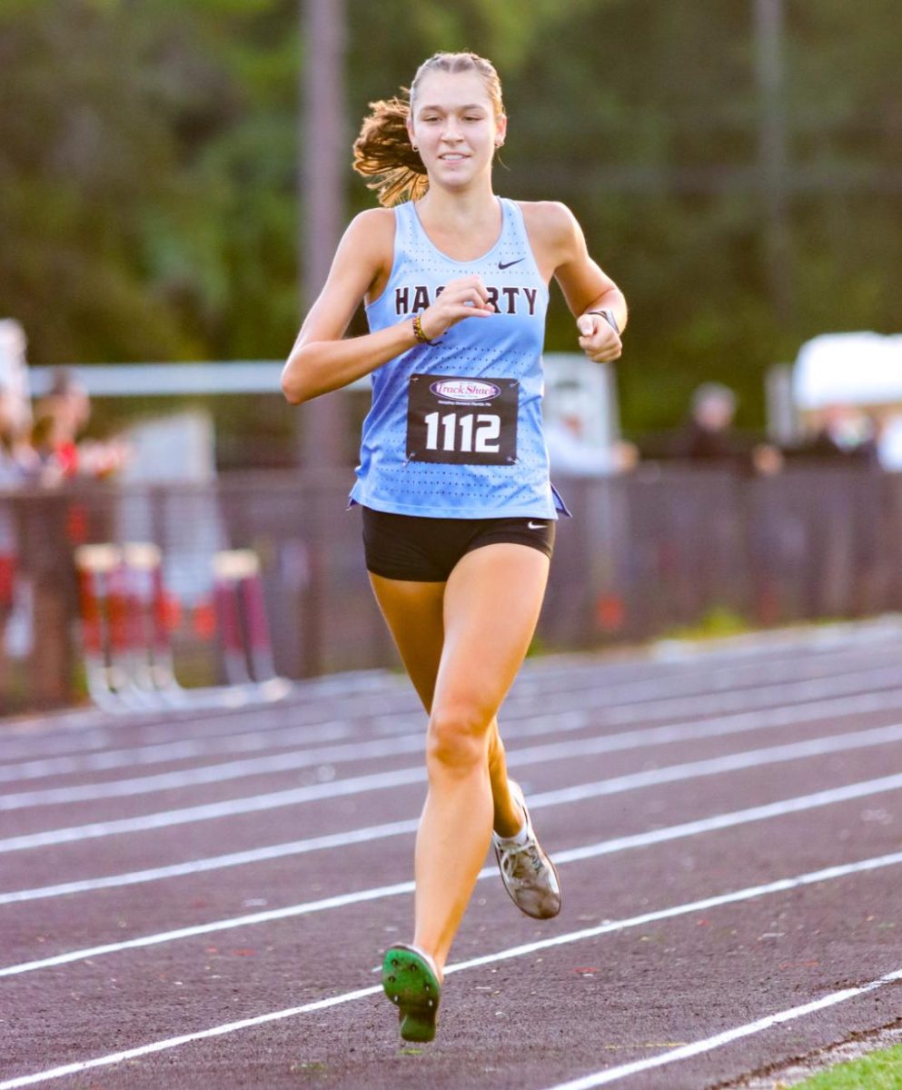 Senior Alaina David sprints to the end of the finish line. David ends with a time of 20:02.