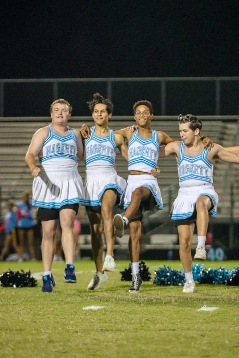 The junior and senior boy powderpuff cheerleaders preform their halftime routine after only three Thursday practices to prepare. From left to right: Beau Campbell, Amin Nouri, Eduardo Ramirez and Ethan Peabody. 
