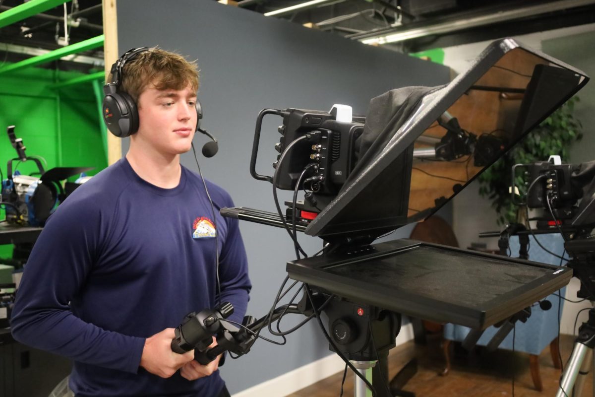 Sophomore Charles Dean stands attentively during the production of Woof TV