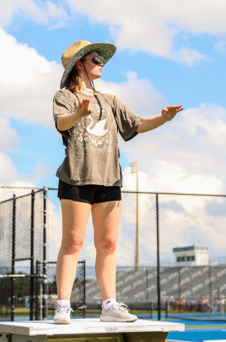 Junior Antonia Hoffman watches the other drum majors as they lead an afterschool band rehearsal.