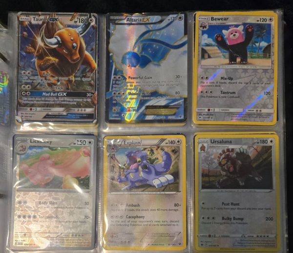 Zafarbek Tokhirjonov shows his Pokemon card collection. 