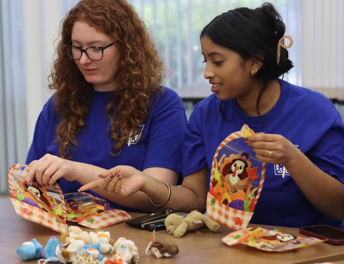 Seniors Annabel Broggy and Samika Unnithan stuff goodie bags during a volunteer event for National Honor Society. Photo by Analie De-Leon Barria