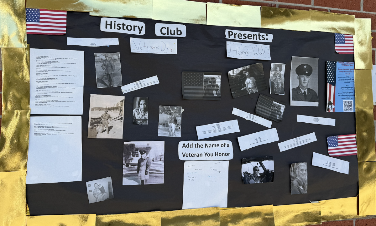 The History Club board is located outside of the cafeteria. 