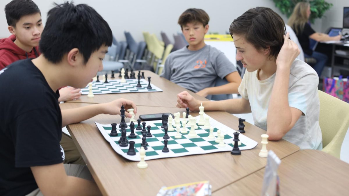 Chess Club members play chess during the tournament. Concentration is key.
