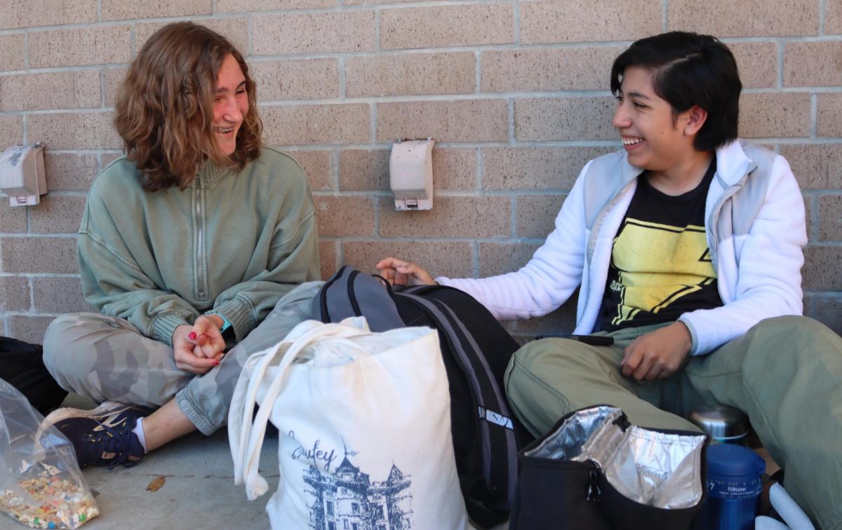 Sophomores Natalya Larsen and Alex Quiroz laugh over a joke. They hang out during their shared lunch period.