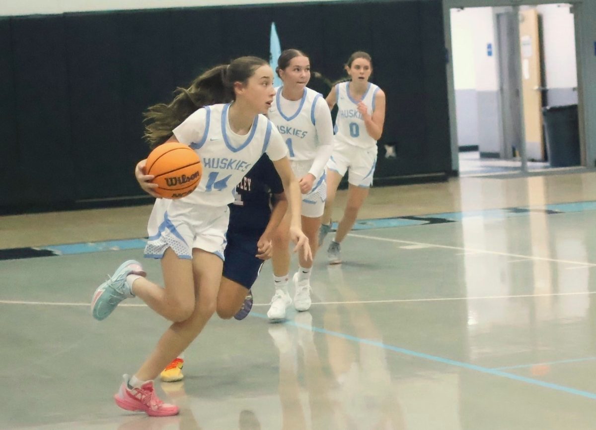Freshman Camdyn Reagan drives the ball down the court. Reagan had six points in the win against Lake Brantley.