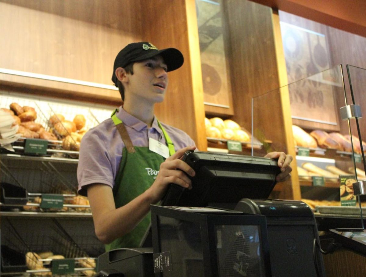 Junior Johnny Tirado is working at the cash register at a local Panera. Being friendly, polite and understanding are all good skills when talking to customers.
