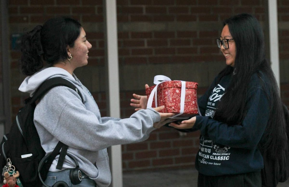 Sophomores Nicole Cui and Zara Valencia exchange gifts for the holidays. Gift giving is a great way to get into the holiday spirit. 
