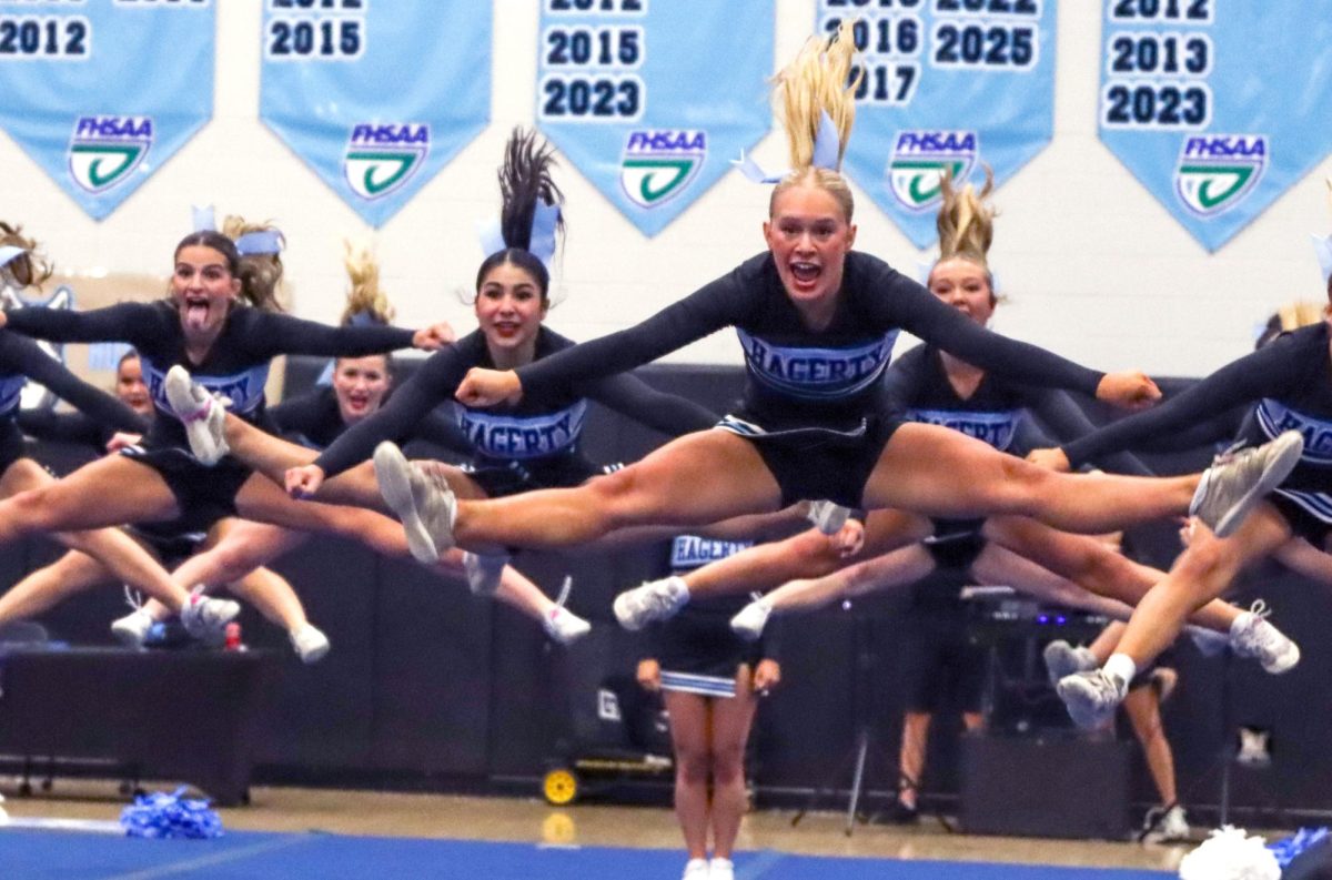 In the first competition of the season, the Husky Cheer Challenge, senior Aubrey Rockwell performs a jump toe touch with the varsity team. The team won first place in the state last season.