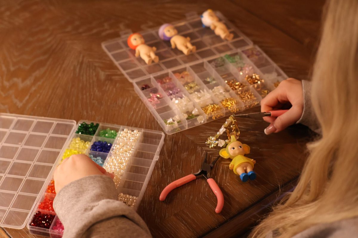 Junior Avery Clegg works on making a Sonny Angel keychain. Clegg sells her keychains on Depop, along with other collectables. Photo | Avery Clegg