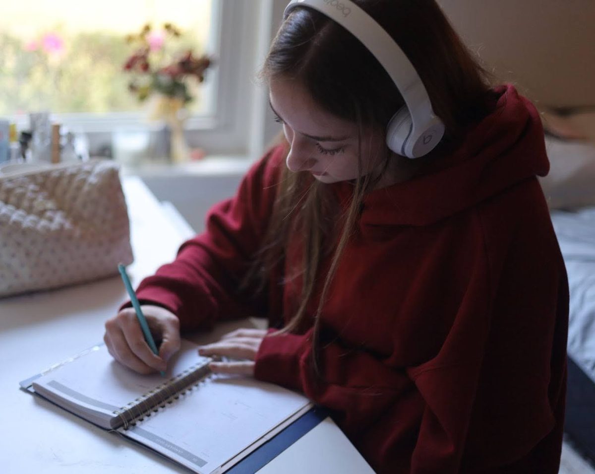 Sophomore Zoe Spencer writes in her planner. Having a planner can keep you updated on any assignment due dates, gamedays and other important events. 
