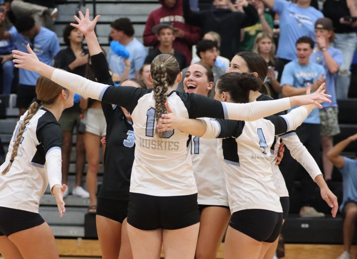 The varsity volleyball team celebrates during a game against Oviedo. It is extremely common for volleyball athletes to play on youth or club teams before high school and during the off-season.