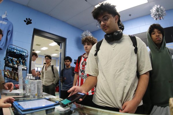 Freshman Derick Alyahya buys lunch from the cafeteria. With state and federal food guidelines focusing on healthy changes, it is unclear how the new rules will impact school lunches.
