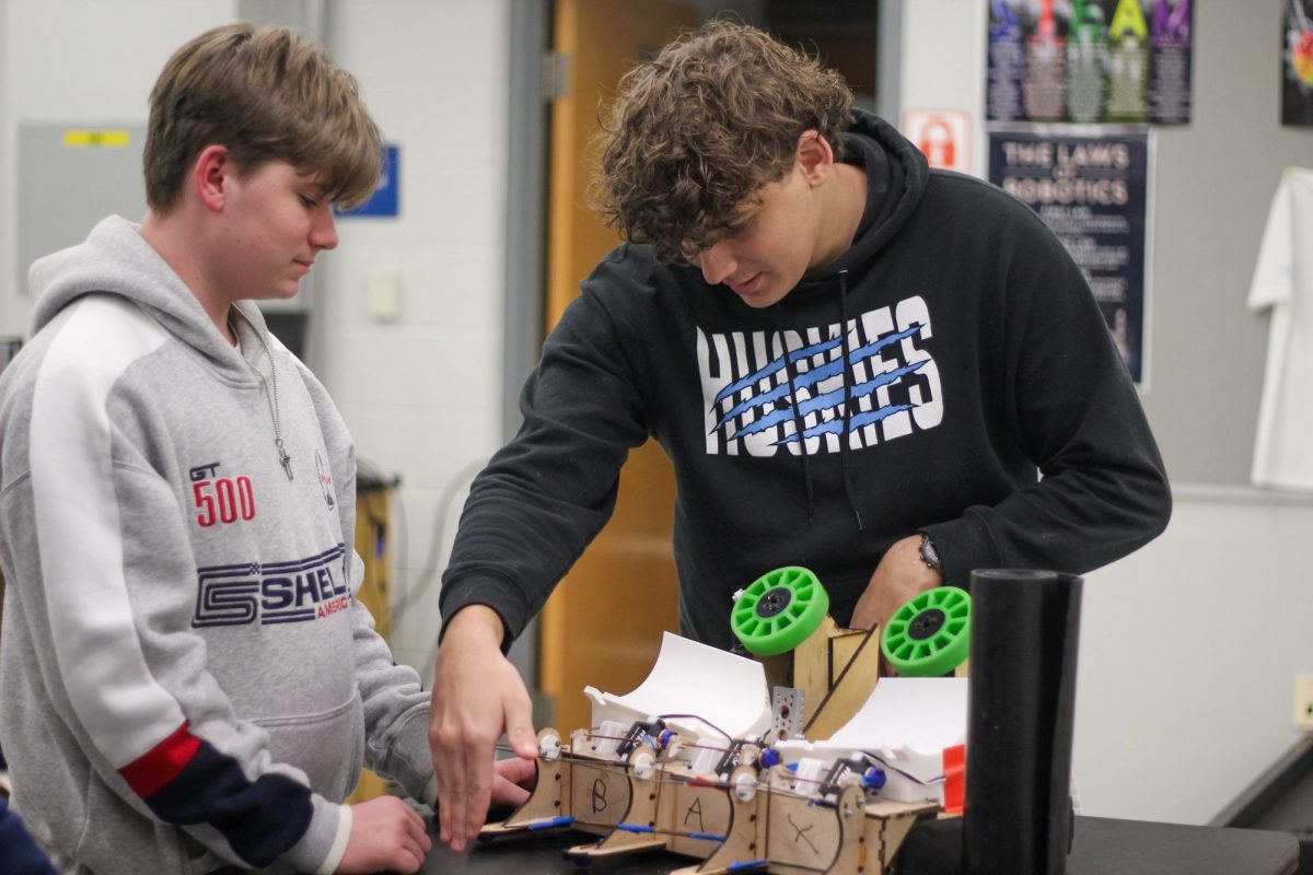 Freshman Zachary Culbert and senior Daniel Aguilar construct a macromancers' next robot. Robotics requires creative thinking and problem solving to solve unique challenges. (Photo by Syunta Fukanaga)