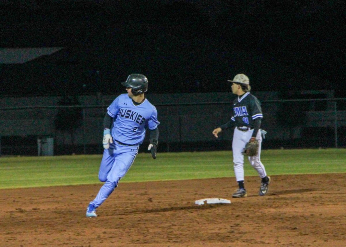 Junior James Austin runs the bases against Masters Academy. The team won 11-7. 