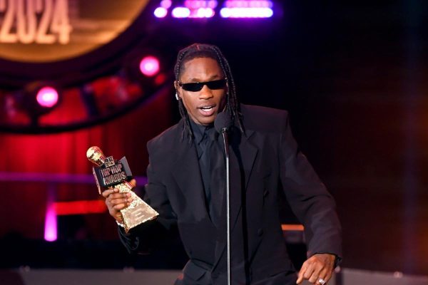Travis Scott accepts a BET award on stage. Though widely criticized for his problematic lyrics, Scott remains one of the most popular rappers today. (Courtesy of Wikimedia Commons)
