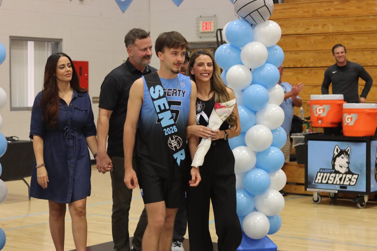 Senior Pierson Boss walks onto the court as he is recognized during Senior Night celebrations. Surrounded by cheers from teammates and the crowd, the moment highlights his impact and years of dedication to the program.