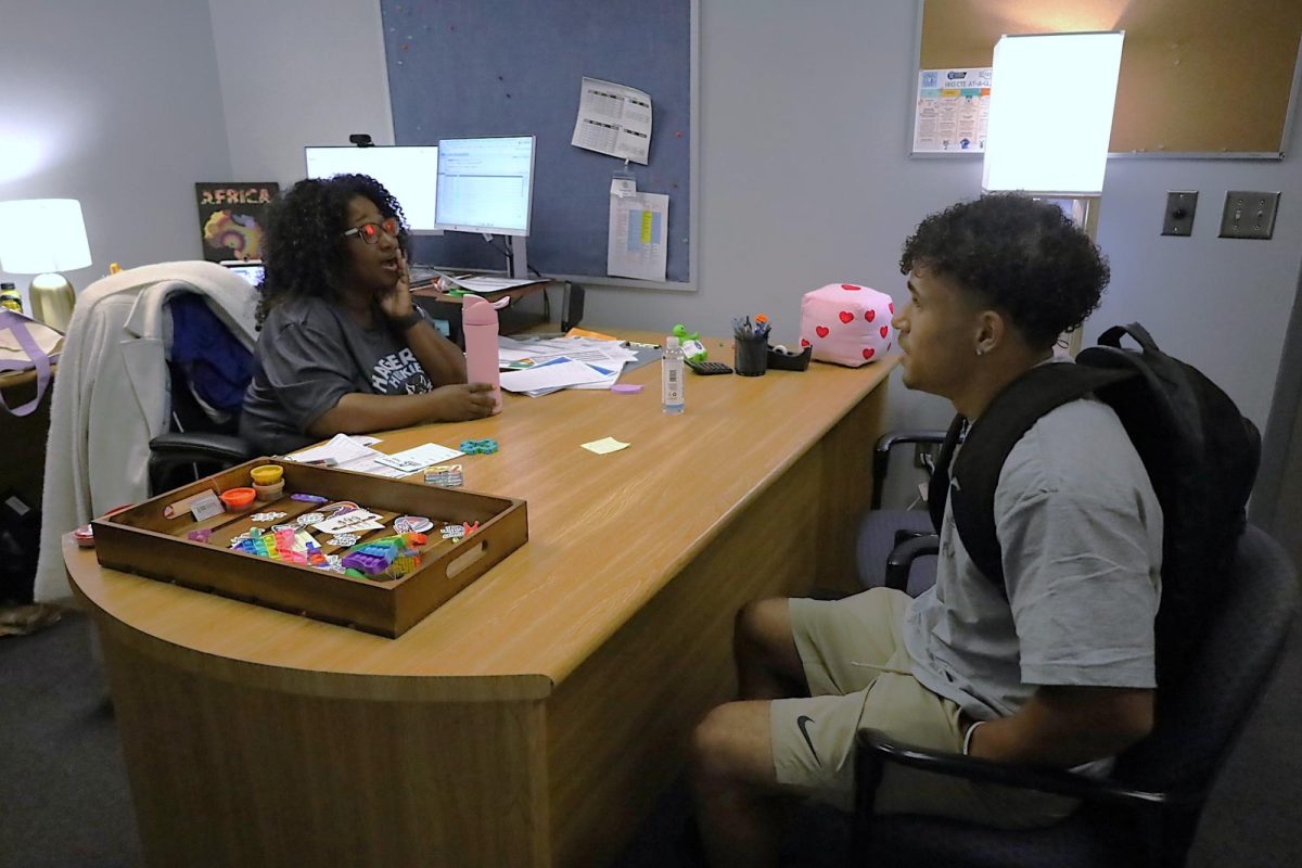Junior Miles Painter discusses college-related issues with counselor Tonya Mcintyre. Students who need assistance on college processes can see their counselor.