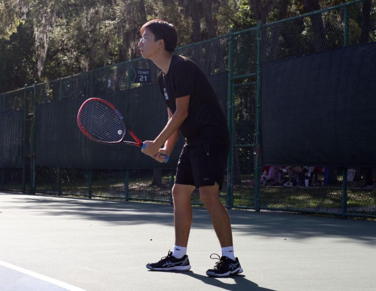 Senior Jerry Liu waits to hit his opponent’s serve back. Despite the loss, Liu put in his best effort against his Lake Brantley rival and finished with a score of 6-2, 6-1. 