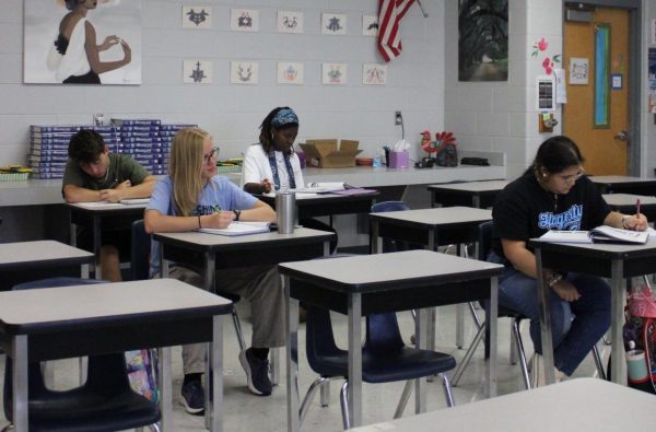 Empty desks surround a small group of students in Matt Malkovich's sixth period Government class. Online classes and other developments have led to lower enrollment, which has dramatically impacted funding.