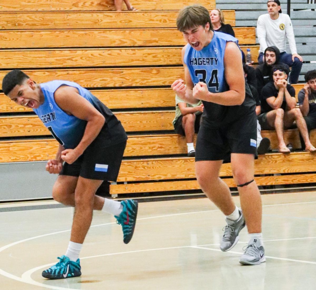 Seniors Marley Evans and Gavin Miller celebrate winning a point against Lake Mary. Though the team lost 3-2 to Lake Mary, they finished the season with a 16-10 record. (Photo by Kaden De La Rosa).