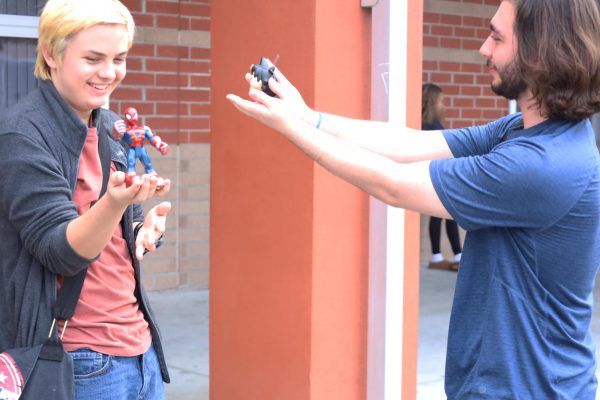 Juniors Nicolas Fennessy and Luke Krise play with superhero action figures. Recently, superhero media has shifted to deeper storytelling, strengthening fans' connection to their favorite characters