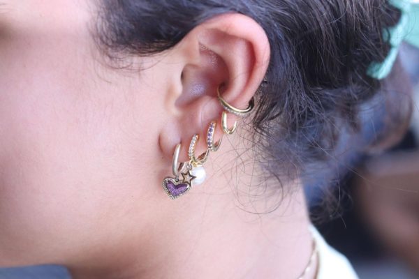 Freshman Juliana Acosta participates in the popular stacked earring trends. Among teenagers today, it is much more common for them to have many piercings. 